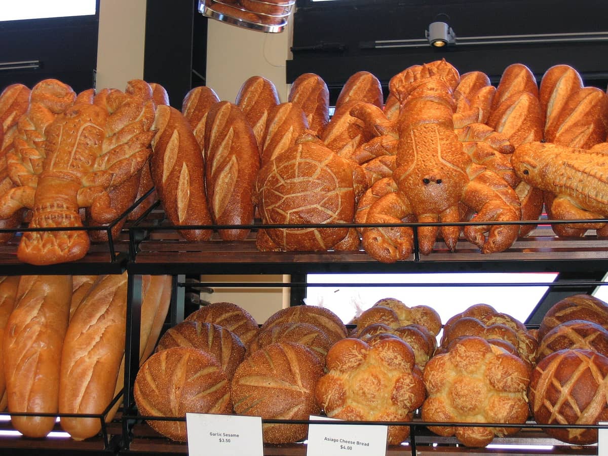 Bakery display of San Francisco sourdough bread, including loaves shaped like animals such as crabs, at Boudin Bakery.