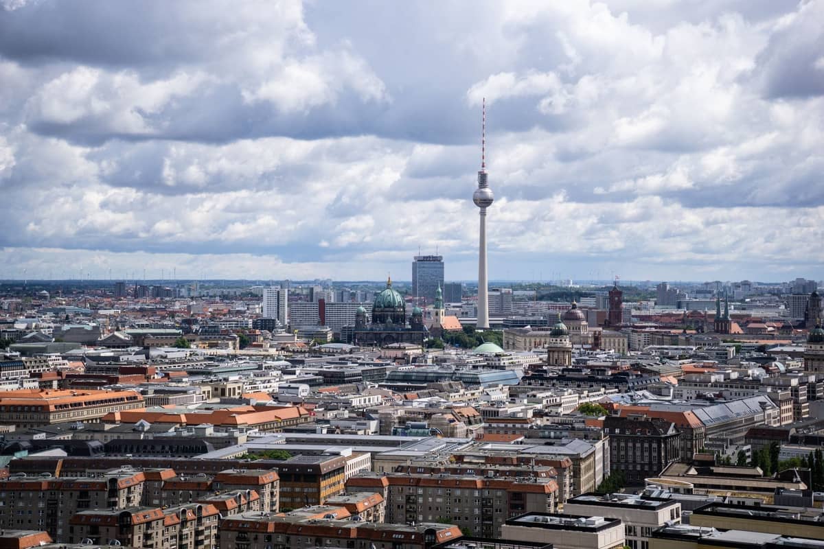 Vue aérienne large de Berlin montrant des quartiers distinctifs, la Tour de Télévision de Berlin, la Cathédrale de Berlin et des ensembles de bâtiments résidentiels et commerciaux.