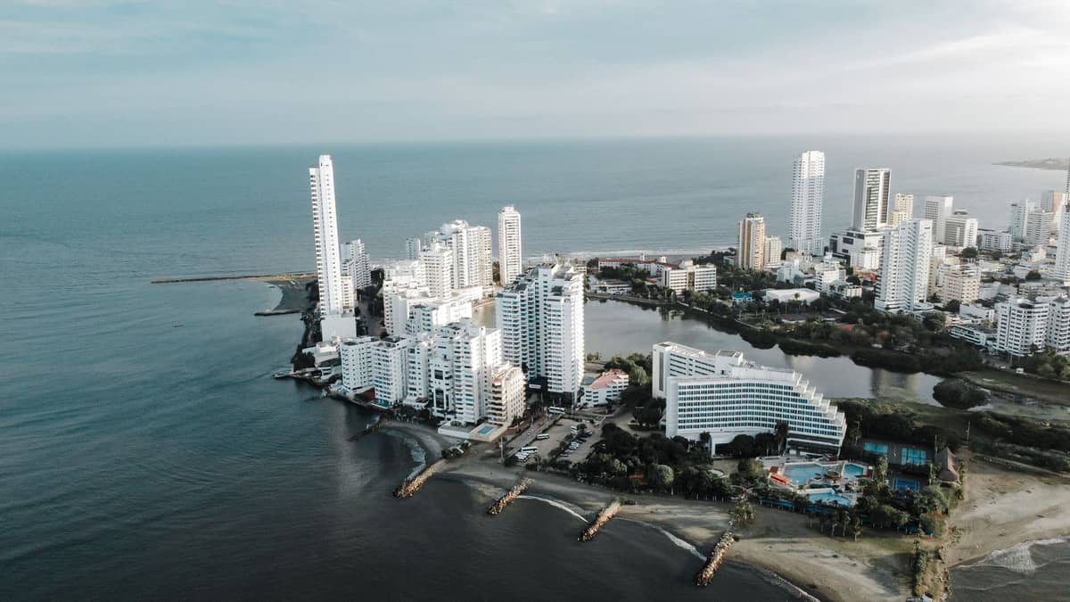 Aerial view of Bocagrande and El Laguito, Cartagena, showing high-rise hotels, sandy beaches, and beachfront resort zone beside the Caribbean Sea.