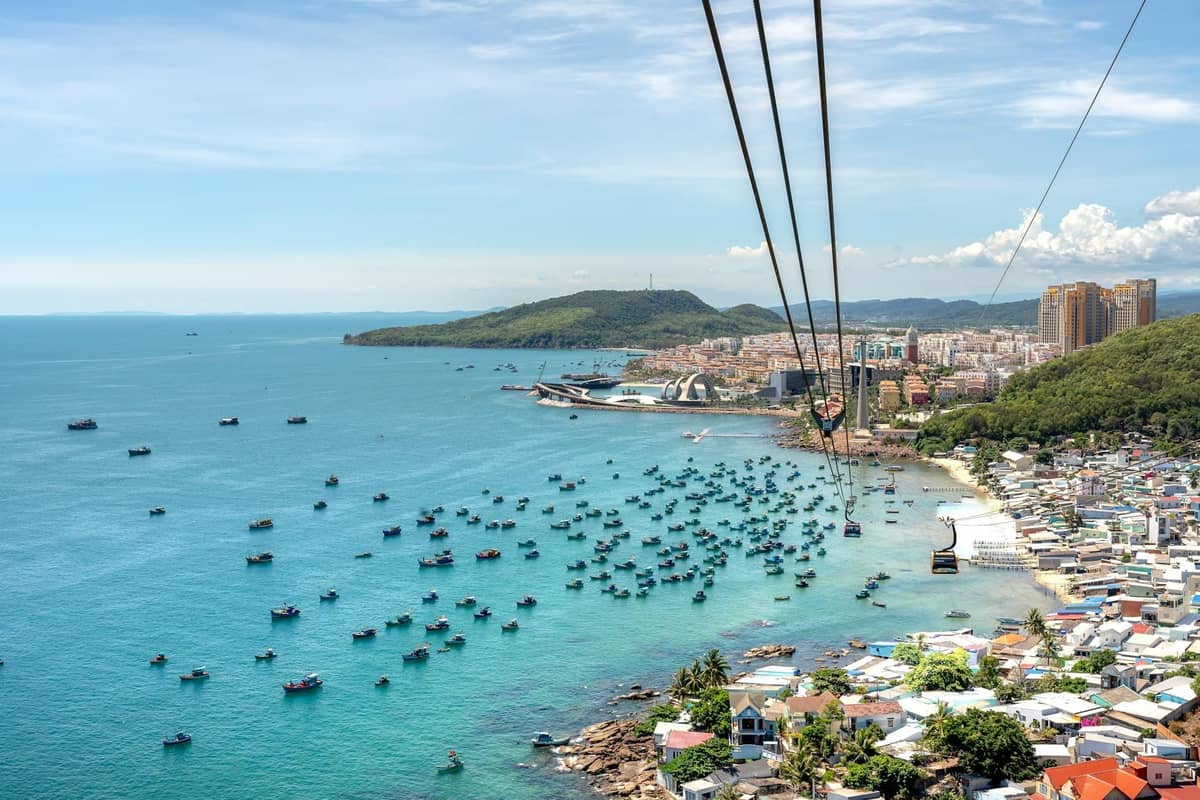 An Thoi Phu Quoc with fishing harbor, coastal town, and Hon Thom cable car over turquoise sea