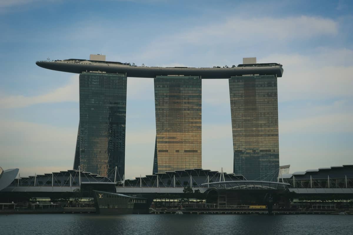Marina Bay Sands hotel with its three towers and sky park, seen at dusk across the bay in Singapore.